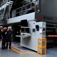Operadores de prensa de Minipak frente a la prensa de rotograbado de BOBST en la planta de producción del convertidor de empaques flexibles colombiano.