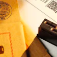 Shipping envelope with hazardous battery warning and electronic component