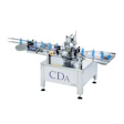 CDA Solo automated bottling and labeling packaging machine with blue bottles