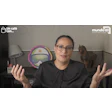Professional presenter gesturing during a video conference with office decor