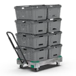 Stacked gray industrial storage crates on mobile transport cart with wheels