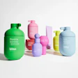 Colorful Isima skincare bottles in green, pink, blue, purple, and yellow