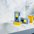 Blue and yellow medication boxes with herbal tea and chamomile flowers