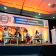 Panel discussion at ExpoPack Mexico 2026 conference featuring four speakers seated on stage with warm orange lighting and blue branding backdrop