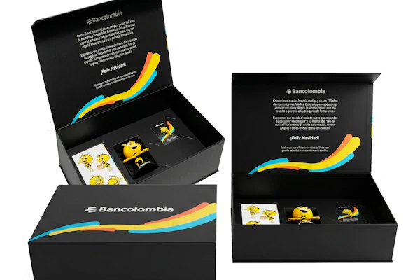 Bancolombia branded luxury gift box set with black packaging, colorful gradient wave design, and promotional merchandise items