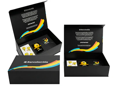 Bancolombia branded luxury gift box set with black packaging, colorful gradient wave design, and promotional merchandise items