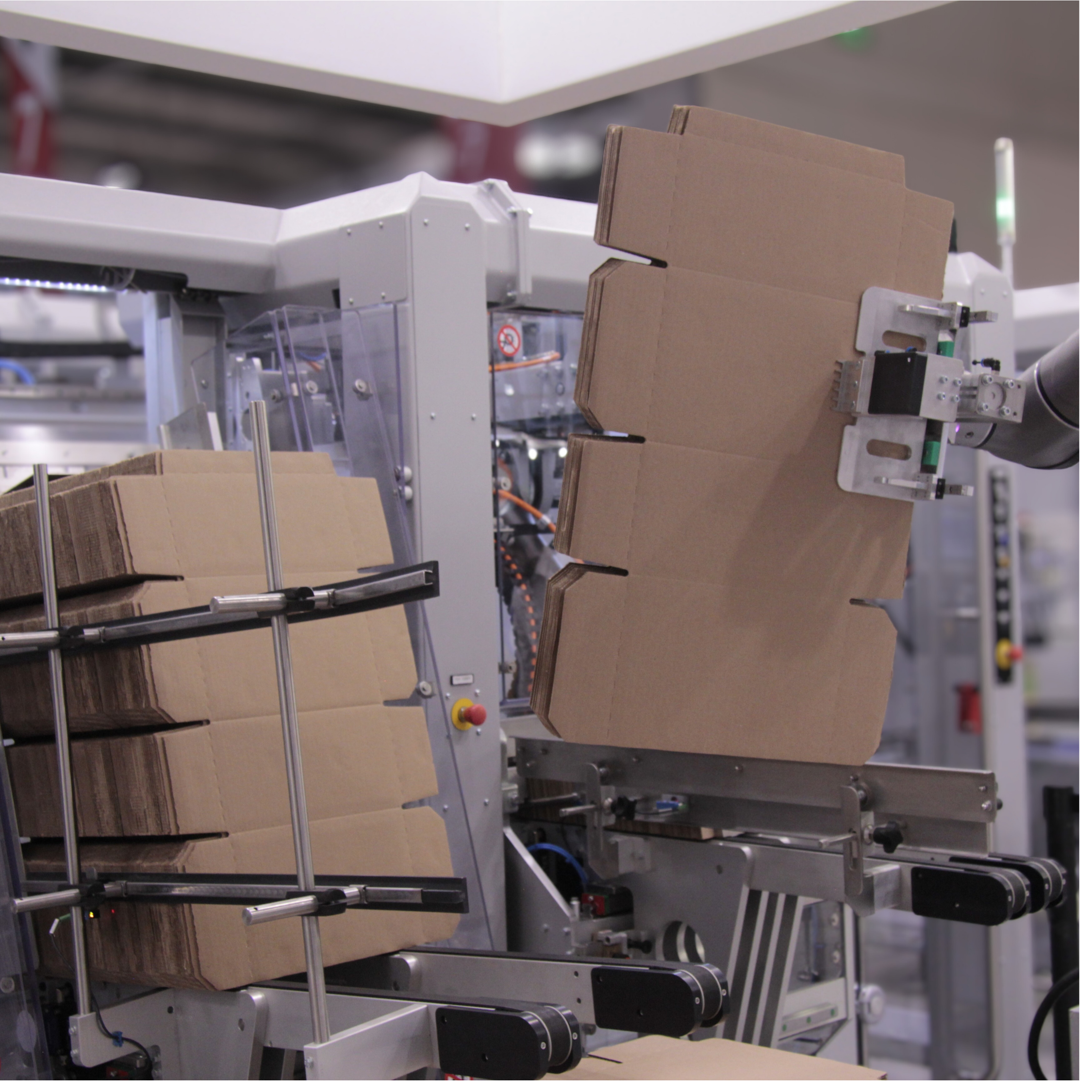 Industrial packaging equipment with cardboard boxes in a manufacturing facility