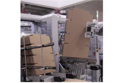 Industrial packaging equipment with cardboard boxes in a manufacturing facility