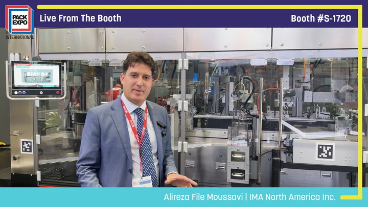Professional presenter in blue blazer at Pack Expo booth #S-1720 standing before industrial packaging machinery display