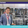 Professional presenter in blue blazer at Pack Expo booth #S-1720 standing before industrial packaging machinery display