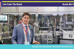 Professional presenter in blue blazer at Pack Expo booth #S-1720 standing before industrial packaging machinery display
