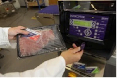 Person holding packaged product while viewing digital display screen in retail or demonstration setting