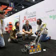 Team members demonstrate a robotics competition robot at the Future Innovators Robotics Showcase, sponsored by Schneider Electric.