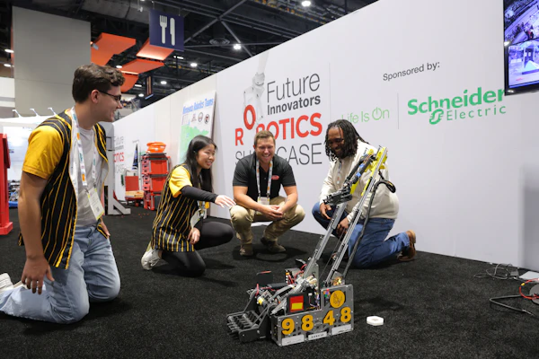 Team members demonstrate a robotics competition robot at the Future Innovators Robotics Showcase, sponsored by Schneider Electric.