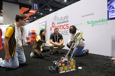 Team members demonstrate a robotics competition robot at the Future Innovators Robotics Showcase, sponsored by Schneider Electric.