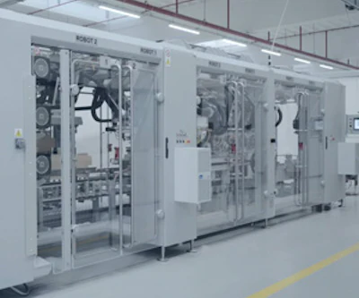 Industrial manufacturing machine with transparent panels and mechanical components in clean facility