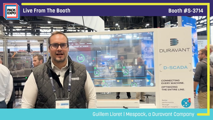 Man presenting at Pack Expo booth #S-3714 with Duravant D-SCADA industrial automation display