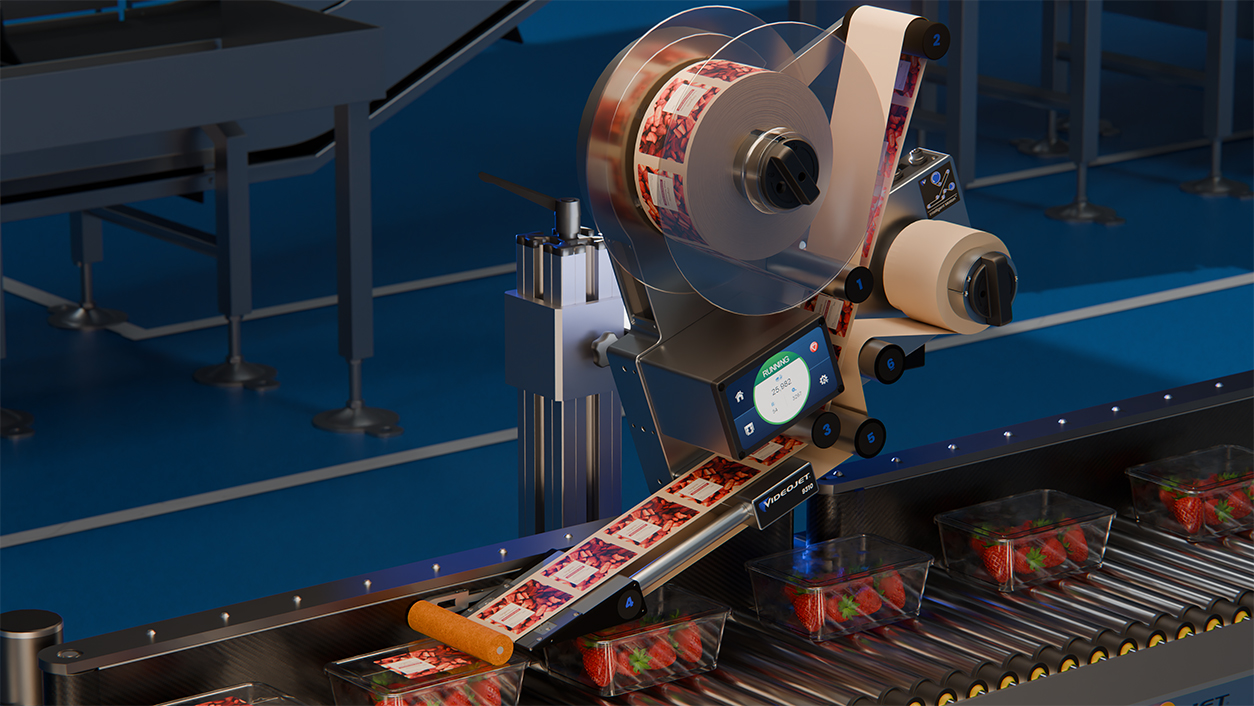 Industrial labeling machine applying labels to products on a blue conveyor belt production line