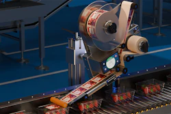 Industrial labeling machine applying labels to products on a blue conveyor belt production line