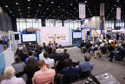 Large conference audience seated in auditorium attending Innovation Edge presentation at trade show event
