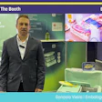 Professional presenting at Pack Expo booth LL-9304 showcasing packaging solutions with green backdrop and product displays