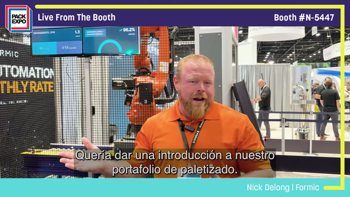 Nick DeLong from Formic speaking at Pack Expo booth N-5447, discussing pallet solutions with industrial machinery visible in background