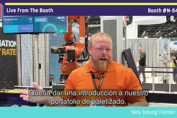 Nick DeLong from Formic speaking at Pack Expo booth N-5447, discussing pallet solutions with industrial machinery visible in background