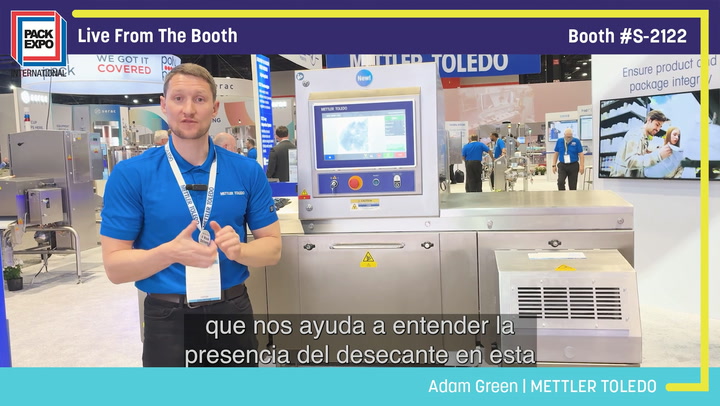 Trade show presenter demonstrating METTLER TOLEDO packaging equipment at Pack Expo booth S-2122