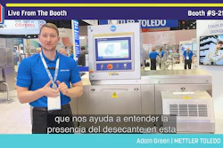 Trade show presenter demonstrating METTLER TOLEDO packaging equipment at Pack Expo booth S-2122